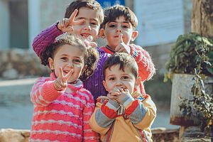 four small Syrian children posing for camera
